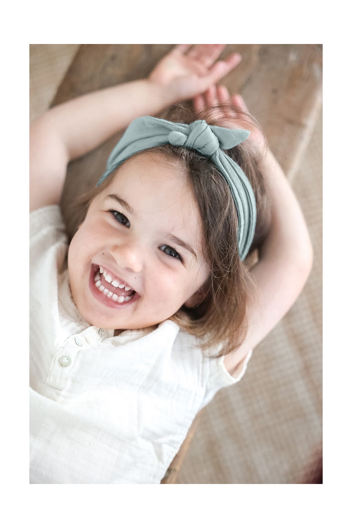 Pretty cotton gauze headband with a solid-color, adjustable bow for babies and little girls
