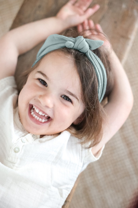 Pretty cotton gauze headband with a solid-color, adjustable bow for babies and little girls